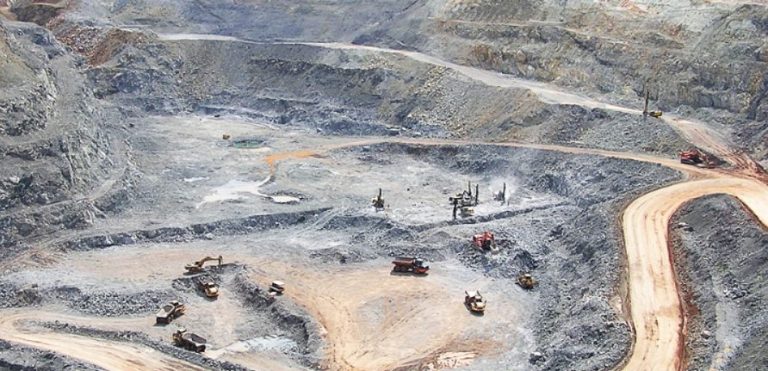 Open pit of the Chatree Gold Mine with excavators and haul trucks at work